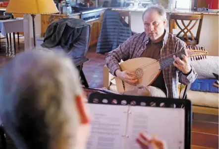  ??  ?? ABOVE: Mark Rimple of West Chester, Pa., plays the lute with vocalist Ryland Angel of New York City and the rest of the members of Severall Friends during a rehearsal Tuesday for their upcoming show on Halloween, Shadows of the Night.