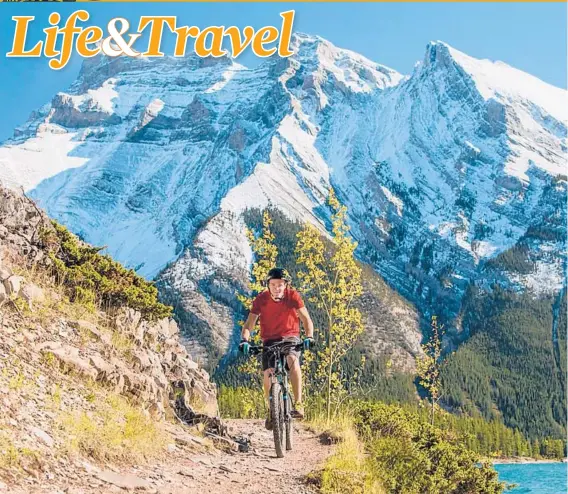  ?? PAUL ZIZKA/BANFF & LAKE LOUISE TOURISM ?? Biking near the glacial Lake Minnewanka in the Banff area.