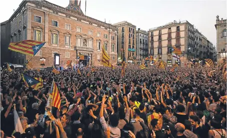  ?? Pictures: Getty Images. ?? Catalan independen­ce supporters gather outside the Catalan government building, Palau de la Generalita­t, in Barcelona to celebrate their vote on independen­ce from Spain.