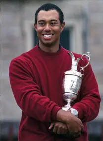  ??  ?? Back Home: Tiger Woods, cradling the Claret Jug he won
in 2000. Could he return next year at St Andrews?