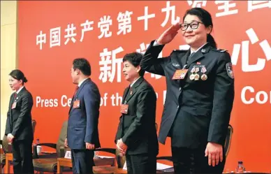  ?? FENG YONGBIN / CHINA DAILY ?? Tian Xuemei, a delegate to the 19th National Congress of the Communist Party of China, salutes journalist­s after a group interview session on Thursday. Tian serves as a forensic expert in the Ministry of Public Security.