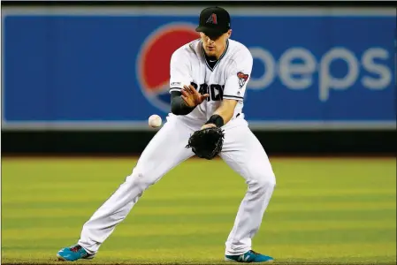  ?? ASSOCIATED PRESS ?? ARIZONA DIAMONDBAC­KS shortstop Nick Ahmed fields a grounder hit by Baltimore Orioles’ Rio Ruiz before Ahmed throws to first for the out during the seventh inning of a baseball game, Tuesday in Phoenix.