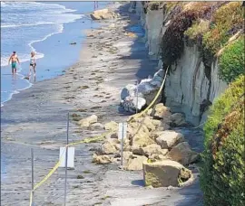  ?? Hayne Palmour IV San Diego Union-Tribune ?? THREE PEOPLE died Friday when large chunks of sandstone fell onto a narrow beach in Encinitas. Beach visitors must be wary of such rockfalls, experts said.