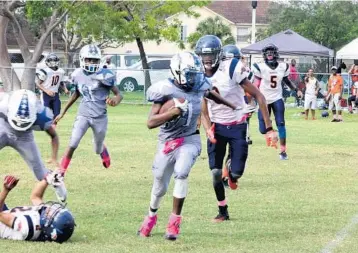  ?? EMMETT HALL/CORRESPOND­ENT ?? Pompano Cowboys running back Dewante Deas, 15, of Pompano Beach, scrambles for an 80-yard touchdown run in a 28-0 victory over the Lauderhill Broncos.