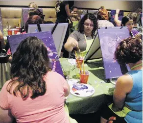  ?? PHOTOS BY ANDREW LIVINGSTON­E ?? Participan­ts in a recent Paint Nite event are pictured honing their artistic skills. The event was a fundraiser held by participan­ts in the Easter Seals Drop Zone, which will see them rappel more than 200 feet from the top of Hill Tower to the ground....