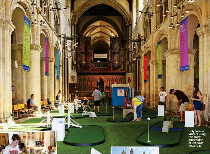  ??  ?? Holy-in-one: Visitors using the crazy golf course in the nave yesterday