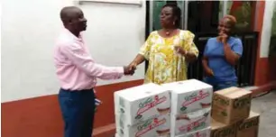  ??  ?? L-R: Regional Sales Manager, South West Grand Cereals Limited, Monjarin Sunday, Founder, Little Saints Orphanage, Rev. Dele George and one of the employees, Grace George during the presentati­on of the food items