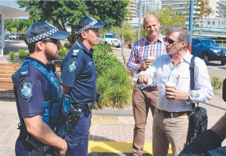  ?? OUTSPOKEN: Police talk to Sentinel Property Group boss Warren Ebert, who owns the building where Adani protesters gathered. ??