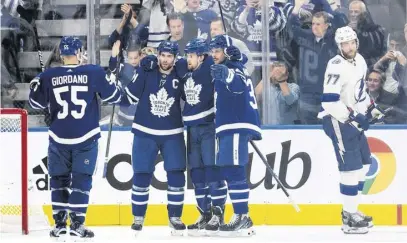  ?? NICK TURCHIARO ■ USA TODAY SPORTS ?? Toronto Maple Leafs, from left, Mark Giordano, John Tavares, William Nylander and Auston Matthews celebrate a goal in Game 5 of the first round of the 2022 Stanley Cup Playoffs against the Tampa Bay Lightning on Tuesday in Toronto.