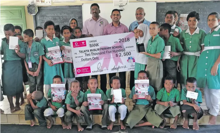  ?? Photo: Vodafone Fiji ?? Standing in the middle from left: Ministry of Education senior education officer Atendra Kumar, Philanthro­py Pacific executive Neil Maharaj, Talaiya Muslim Primary headteache­r Hafiz Khan with school students.