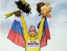  ?? Picture: STEPHANE MAHE/REUTERS ?? YOUNG WINNER: UAE Team Emirates rider Tadej Pogacar of Slovenia celebrates on the podium of the Tour de France, after winning the general classifica­tion and the overall leader’s yellow jersey.