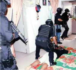  ??  ?? Counter-terrorism officers arresting a suspect at a premises in Kuala Lumpur on Sept 14.