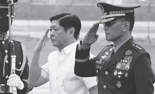  ?? PHOTO BY AP/AARON FAVILA ?? President Ferdinand R. Marcos Jr. salutes with military chief Lt. Gen. Bartolome Vicente O. Bacarro before departing to Beijing last January 3, 2023, at the Villamor Air Base. Marcos on Saturday, January 7, cut short the term of Bacarro, whom he appointed five months ago and replaced him with a retiring general without explaining the surprise move.