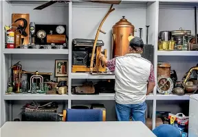  ?? PHOTOS: RYAN ANDERSON / STUFF ?? John Stil’s office bookcase and desk are covered by interestin­g salvaged objects from Nikau Contractor­s work.