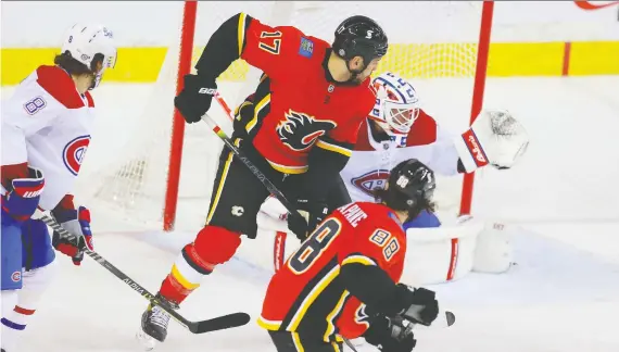 ?? AL CHAREST ?? Flames forward Milan Lucic provides the screen in front of Montreal Canadiens goalie Jake Allen as Dillon Dube's shot finds the back of the net in a crucial 4-2 Calgary victory.