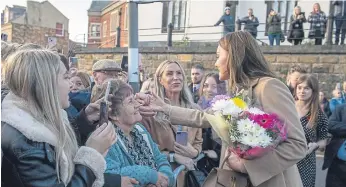  ?? ?? There was a crowd at each side of the centre’s entrance; William greeted those at one side and Kate at the other.