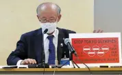  ?? — AP ?? Lawyer Kenji Utsunomiya, a representa­tive of an antiOlympi­cs group, shows an anti-Olympic banner after submitting a petition to the Tokyo government calling for the cancellati­on of the Tokyo Olympics on Friday.