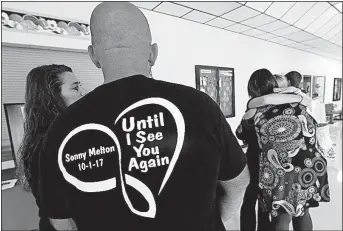  ?? [WADE PAYNE/ THE ASSOCIATED PRESS] ?? A guest at the funeral in Big Sandy, Tenn., on Tuesday for Sonny Melton, one of the 58 people who died in the mass shooting in Las Vegas on Oct. 1, wears a shirt in his honor. Melton, a registered nurse, died trying to help others during the attack.