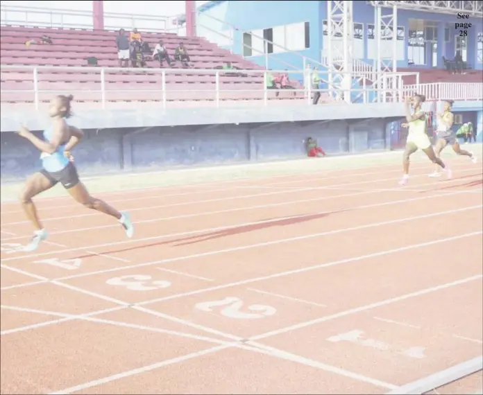  ??  ?? Kenisha Phillips powers across the line in the 200m event in a PB time of 24.91s.