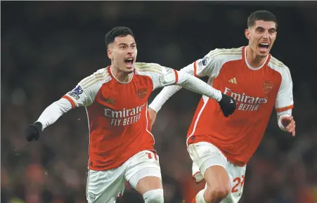  ?? REUTERS ?? Gabriel Martinelli (left) celebrates with Kai Havertz after scoring Arsenal's second goal during a 3-1 Premier League win over title-rival Liverpool at Emirates Stadium in London on Sunday.