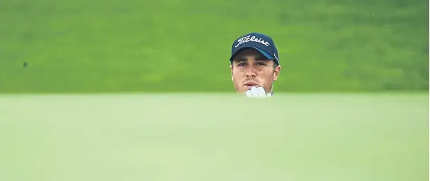  ??  ?? PEEKABOO: American Justin Thomas looks on after playing a shot from a bunker during a practice round at Shinnecock Hills yesterday