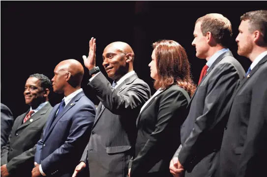  ??  ?? Lee Harris, center, waves during the swearing-in ceremony for Shelby County officials elected on Aug. 2. Harris, 39, officially took over Shelby County mayoral duties on Sept. 1. MARK WEBER / THE COMMERCIAL APPEAL