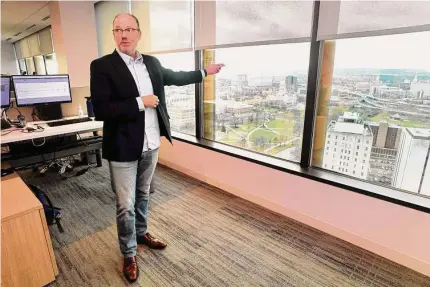  ?? Photos by Ned Gerard / Hearst Connecticu­t Media ?? Dan O’Shea, chief administra­tive officer of Global Atlantic Financial Group, shows the panoramic view of the state Capitol and Bushnell Park during a tour of the company’s offices on the 24th floor of One Financial Plaza in Hartford.