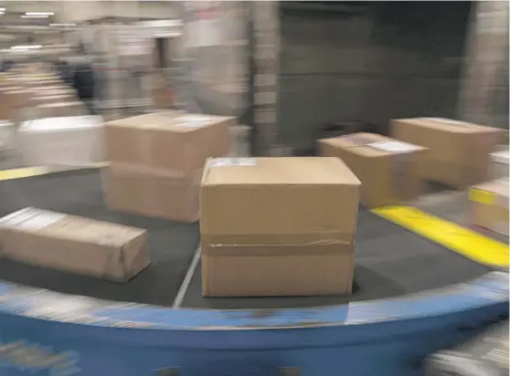  ?? JAE C. HONG/AP FILE ?? Packages move along a conveyor belt while being sorted for delivery at the FedEx regional hub at Los Angeles Internatio­nal Airport last year.