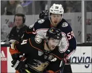  ?? ALEX GALLARDO — THE ASSOCIATED PRESS ?? Ducks center Adam Henrique, front, controls the puck past Blue Jackets right wing Yegor Chinakhov during the second period in Anaheim, Calif. on Feb. 21.