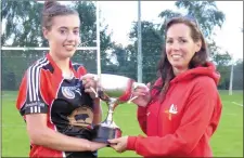  ??  ?? Aoife Gregory of St Kevin’s receives the league trophy from Lorraine Young,Camogie Board Chairperso­n.