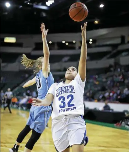  ?? JOHN BLAINE — FOR THE TRENTONIAN ?? Trenton Catholic’s Habbiba Elgizawy (32) goes up for a shot as Notre Dame’s Leah Johnson (10) attempts to block it during a semifinal MCT game at CURE Insurance Arena on Tuesday night.