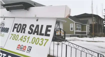  ?? ED KAISER ?? A For Sale sign on a front lawn in Edmonton. The demand for homes in the city increased by 50 per cent in January.