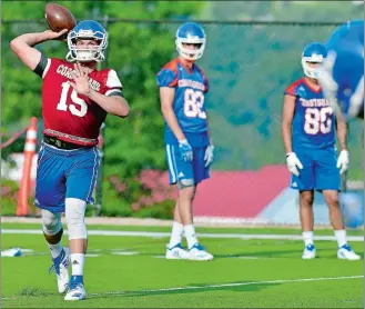  ?? SARAH GORDON/THE DAY ?? Coast Guard quarterbac­k Ryan Jones (15) throws a pass during the team’s first day of practice on Wednesday at Cadet Memorial Field in New London.