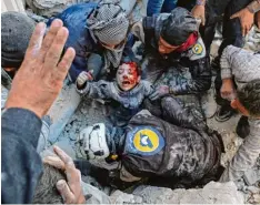  ?? Foto: Ameer Alhabi, afp ?? Weißhelme retten einen kleinen Jungen aus den Trümmern eines Hauses im Ostteil der Stadt Aleppo.