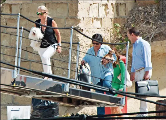  ??  ?? Gilded existence: Lady Green and her pets board the couple’s new £100 million superyacht, Lionheart, in Valletta, Malta