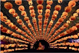  ?? — AFP ?? Visitors walking past a pumpkin lantern show to mark the Halloween in Shenyang, China, on Wednesday.