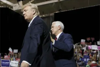  ?? EVAN VUCCI — THE ASSOCIATED PRESS ?? Republican presidenti­al nominee Donald Trump, left, stands with vice presidenti­al candidate Gov. Mike Pence, R-Ind., during a campaign rally, Saturday in Cleveland.