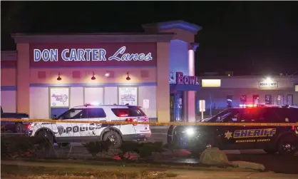  ??  ?? Rockford police vehicles outside the bowling alley where three people were shot dead on Saturday. Photograph: Scott P Yates/AP