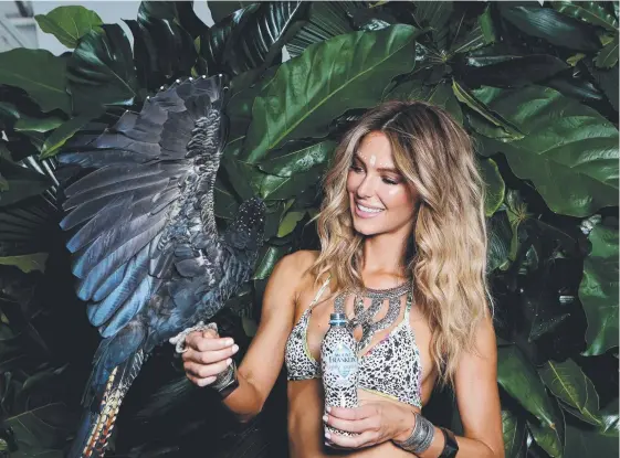  ??  ?? Model Jennifer Hawkins with Mount Franklin sparkling water. Woolworths will soon limit its stock of the popular water brand.