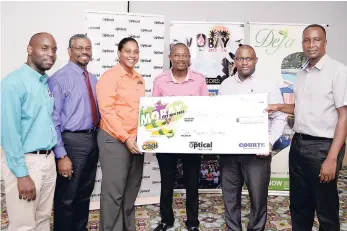  ??  ?? Representa­tives from (from left) Montego Bay Community College, UTech Western Campus, UWI Western Jamaica Campus and Sam Sharpe Teachers College accept the $1 million sponsorshi­p cheque from Courts’ regional manager, Dwight Sanderson (second right)...