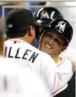  ?? MARC SEROTA/GETTY IMAGES ?? Manager Ozzie Guillen hugs Adam Greenberg in dugout afterwards.