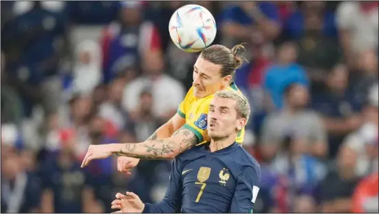  ?? ?? France’s Antoine Griezmann, (front) and Australia’s Jackson Irvine jump for the ball during the World Cup Group D soccer match between France and Australia, at the Al Janoub Stadium in Al Wakrah, Qatar. (AP)