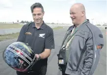  ??  ?? Rudi Zacsko presents Ron McLean with a customized Bell helmet.