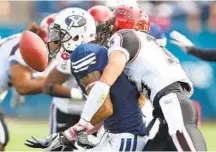  ?? GEORGE FREY AP ?? SDSU’s Jose Perez (right) knocks the ball away from BYU’s Cody Hoffman in the first half in 2010. It was a close, hard-fought game.