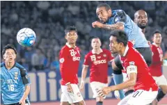  ?? AP ?? Kawasaki Frontale’s Neto, right, heads the ball to score against Muang Thong.