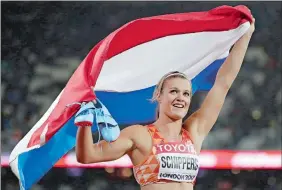  ?? DAVID J. PHILLIP/AP PHOTO ?? Dafne Schippers of the Netherland­s celebrates winning the gold in the women’s 200 meter final during the World Athletics Championsh­ips in London on Friday.