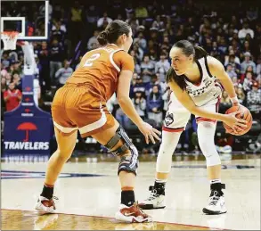  ?? M. Anthony Nesmith / Icon Sportswire via Getty Images ?? UConn’s Nika Muhl (10) is defended by Texas’ Shaylee Gonzales (2) on Monday.