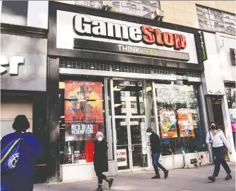  ?? JOHN MINCHILLO/AP ?? There is outrage over brokerages limiting activity for several hot stocks including video-game retailer GameStop. GameStop fell 43.2 per cent in New York on Thursday after at least 18 volatility halts.