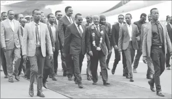  ?? REUTERS/Tiksa Negeri ?? Ethiopia’s Prime Minister Abiy Ahmed welcomes Eritrean Foreign Minister Osman Saleh and his delegation at the Bole Internatio­nal Airport in Addis Ababa, Ethiopia June 26, 2018.