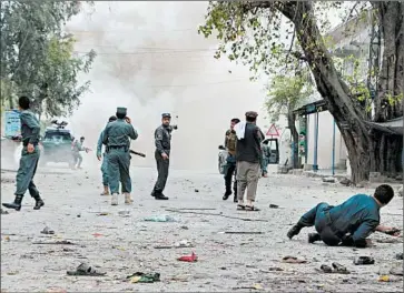  ?? NOORULLAH SHIRZADA/GETTY-AFP ?? A second explosion follows a suicide bombing Saturday outside a bank in Jalalabad, Afghanista­n. The Islamic State group claimed responsibi­lity for the attack, which also injured over 120 people. The Taliban joined in condemning the attack.